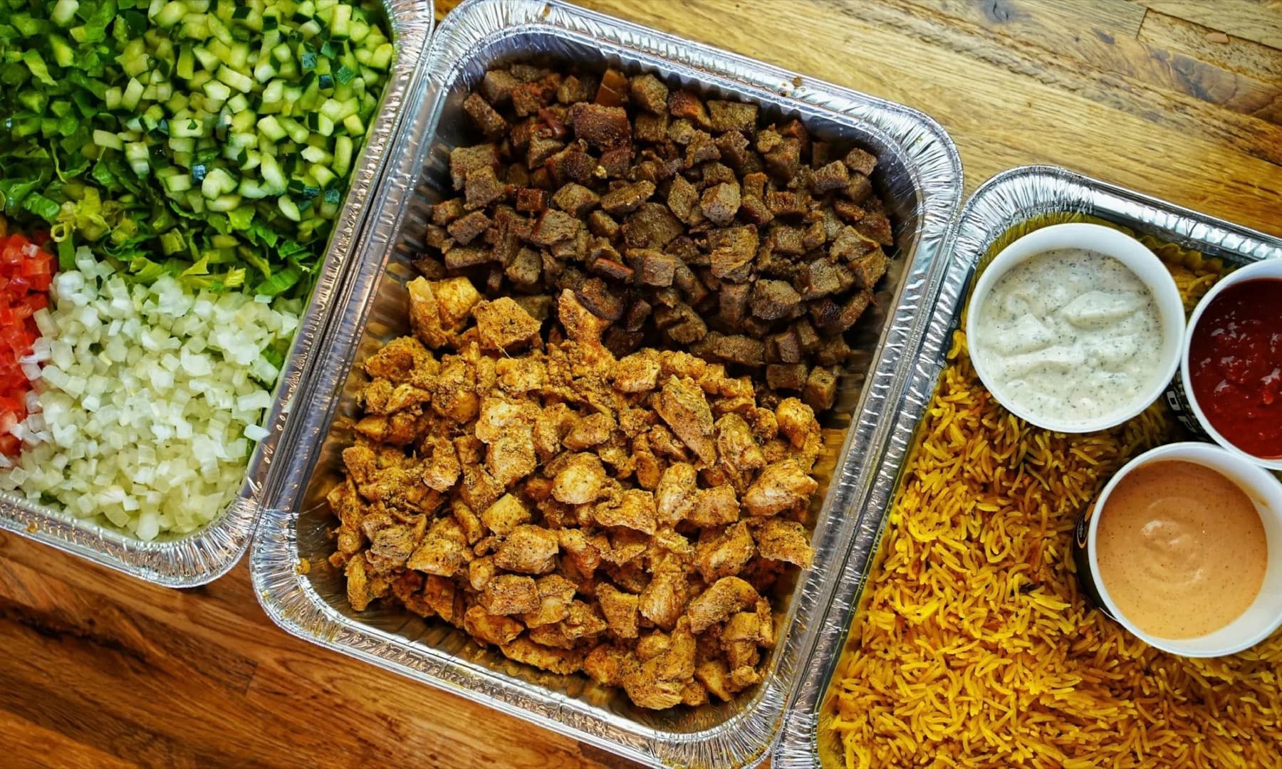 Build-your-own Gyro Bar with grilled proteins, toppings, sauces, and rice